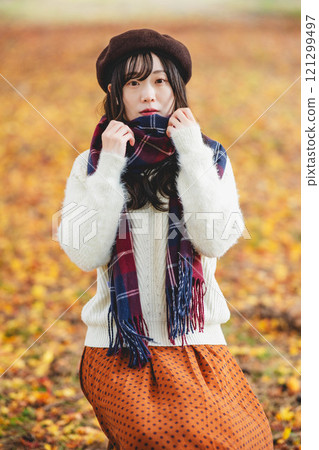Autumn performance and young woman wearing a scarf 121299497