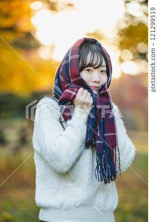 Autumn performance and young woman wearing a scarf 121299519