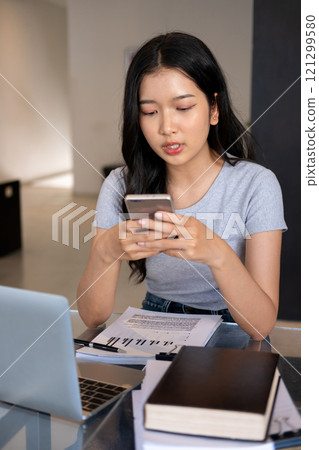 Young woman relaxing with smartphone. Young woman relaxing with smartphone. 121299580