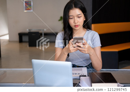 Young woman relaxing with smartphone. Young woman relaxing with smartphone. 121299745