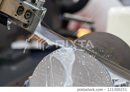The band saw cutting machine cutting the metal shaft parts with coolant method. 121300251