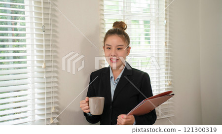 Businesswoman sitting at desk on couch in workplace or at home working on laptop and analyzing data on charts and graphs and writing on papers to make business plan and strategies for company, Businesswoman sitting at desk on couch in workplace or at home working on laptop and analyzing data on charts and graphs and writing on papers to make business plan and strategies for company, 121300319