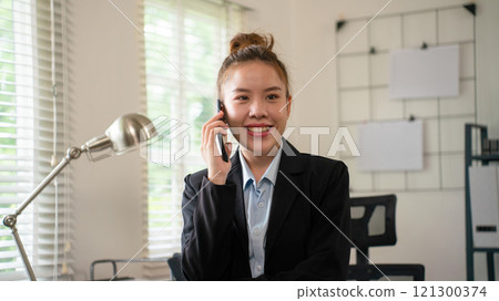 Businesswoman sitting at desk on couch in workplace or at home working on laptop and analyzing data on charts and graphs and writing on papers to make business plan and strategies for company, Businesswoman sitting at desk on couch in workplace or at home working on laptop and analyzing data on charts and graphs and writing on papers to make business plan and strategies for company, 121300374