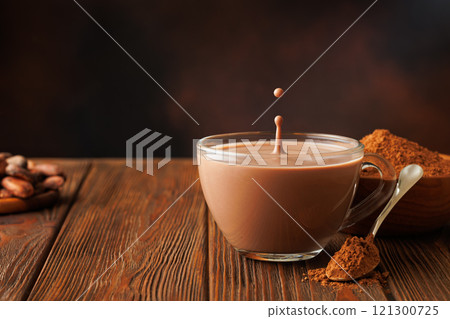 cocoa with splash and drop in cup on table cocoa with splash and drop in cup on table 121300725