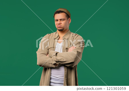 Dissatisfied Offended Man Keeping Arms Crossed And Staring At Camera With Sceptical distrustful look, feeling mad at someone. Human facial expressions, emotions and feelings. Body language. Dissatisfied Offended Man Keeping Arms Crossed And Staring At Camera With Sceptical distrustful look, feeling mad at someone. Human facial expressions, emotions and feelings. Body language. 121301059