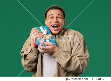 Excited Man Hold Gift Box With Bow. He Is Happy And Flattered By Attention. Guy Excited Man Hold Gift Box With Bow. He Is Happy And Flattered By Attention. Guy 121301209