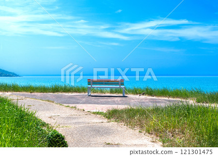 A bench overlooking the sky and sea 121301475