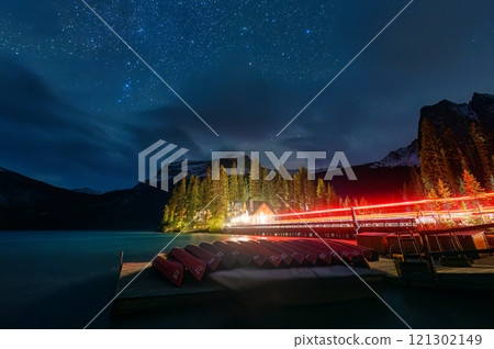 Night scene of Emerald Lake with wooden lodge, starry and canoe surrounding by rocky mountains in Yoho national park, Canada Night scene of Emerald Lake with wooden lodge, starry and canoe surrounding by rocky mountains in Yoho national park, Canada 121302149