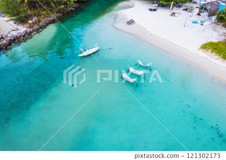 Koh Kood Island with cradle, boat in turquoise sea by the beach in summer 121302173