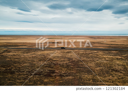Icelandic landscape with van driving through grassland in autumn Icelandic landscape with van driving through grassland in autumn 121302184
