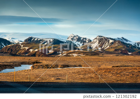 Volcanic mountain range with snow covered on remote wilderness in Iceland Volcanic mountain range with snow covered on remote wilderness in Iceland 121302192