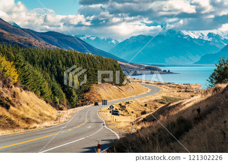 Scenic Peters lookout with winding road and Mount Cook and Lake Pukaki on sunny day in autumn at New Zealand Scenic Peters lookout with winding road and Mount Cook and Lake Pukaki on sunny day in autumn at New Zealand 121302226