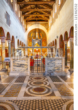 The Basilica of Santa Maria in Cosmedin showcases its beautiful interior, featuring intricate mosaics, elegant arches, and a serene atmosphere 121302532