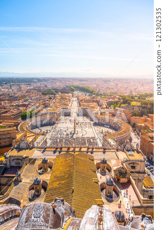 Visitors gather in St. Peter's Square, enjoying the warm sunlight and stunning architecture of St. Peter's Basilica, while the peaceful atmosphere surrounds this iconic location. Visitors gather in St. Peter's Square, enjoying the warm sunlight and stunning architecture of St. Peter's Basilica, while the peaceful atmosphere surrounds this iconic location. 121302535
