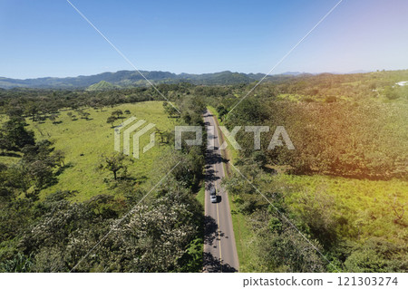 Small truck driving on asphalt road 121303274