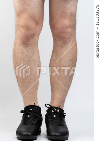 Man athlete legs in black lace sport shoes 121303278