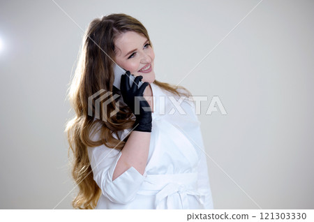Portrait young woman with protective mask and gloves holding smartphone - coronavirus pandemic alert 121303330