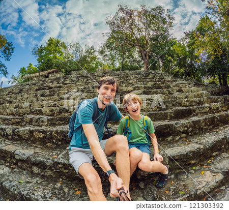 Father and son tourists exploring the ancient ruins of Coba, Mexico. Family bonding, cultural heritage, and adventure travel concept in the Yucatan Peninsula 121303392
