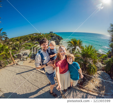 Family of four tourists, mother, father, and two sons, posing in front of a majestic Mayan pyramid in Tulum. Perfect for cultural exploration, family travel, and discovering ancient history. Travel Family of four tourists, mother, father, and two sons, posing in front of a majestic Mayan pyramid in Tulum. Perfect for cultural exploration, family travel, and discovering ancient history. Travel 121303399