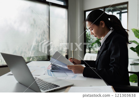 Accountant working on financial data analysis dashboard on paper as marketing indication for business strategic planning Accountant working on financial data analysis dashboard on paper as marketing indication for business strategic planning 121303638