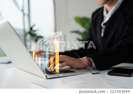 Business woman analyzes profit ability of working with digital graph, positive indicators in 2024 Business woman analyzes profit ability of working with digital graph, positive indicators in 2024 121303644