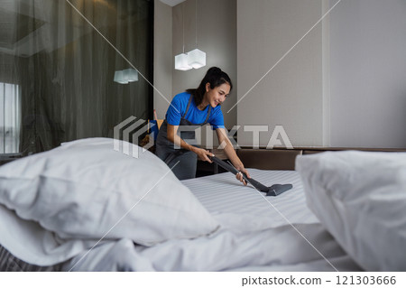 online cleaning service, hotel cleaning service clean up bedroom after guests arrive . housekeeper cleaning dust and clean bed with a vacuum cleaner. Housekeeping and house cleaning service online cleaning service, hotel cleaning service clean up bedroom after guests arrive . housekeeper cleaning dust and clean bed with a vacuum cleaner. Housekeeping and house cleaning service 121303666