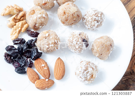 Close up Laddu and almonds and blue raisins. Indian sweets concept Close up Laddu and almonds and blue raisins. Indian sweets concept 121303887