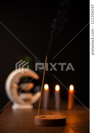 Burning aromatic incense smoky stick for meditation and relaxing. Aromatherapy smoke for yoga concept. 121304297