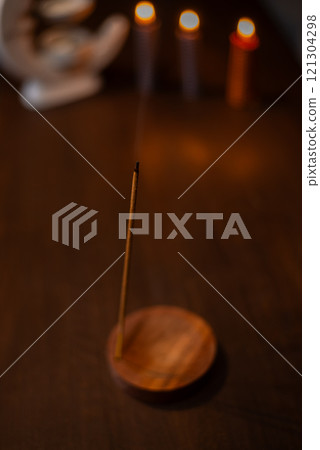 Burning aromatic incense smoky stick for meditation and relaxing. Aromatherapy smoke for yoga concept. Burning aromatic incense smoky stick for meditation and relaxing. Aromatherapy smoke for yoga concept. 121304298