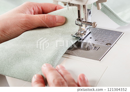 Sewing machine, stitching fabrics, needle in a round plan 121304352