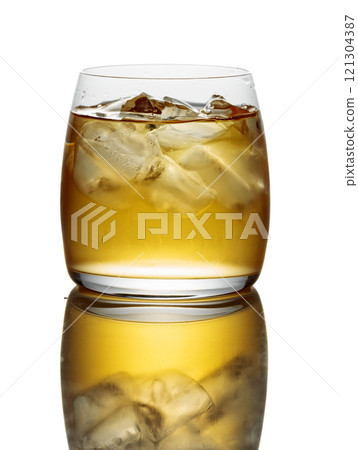 Whiskey with ice in a glass on a white background. 121304387