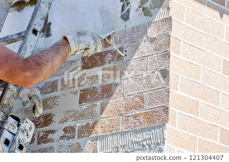 Facade cladding with flexible thin brick veneer panel reinforced with plastic mesh. Facade cladding with flexible thin brick veneer panel reinforced with plastic mesh. 121304407