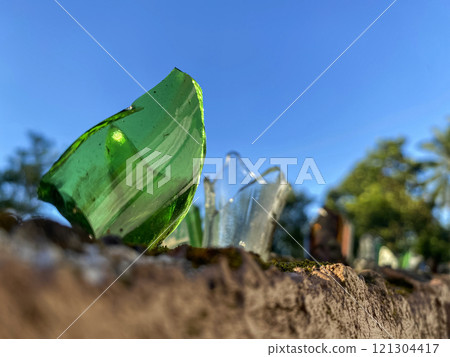broken glass bottles on the fence to protect private territory from trespassing 121304417