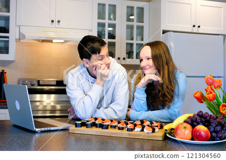 Sushi with soy sauce next to a laptop, Asian takeout food 121304560
