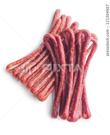 Smoked kabanos. Mini dried thin sausages isolated on white background 121304987