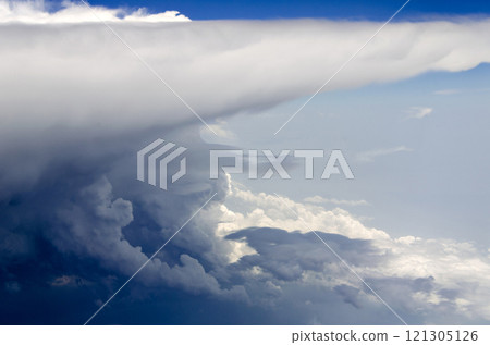 Blue sky and silky white clouds with stunning shapes and colorful views over the clouds 121305126