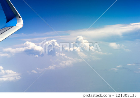 Blue sky and silky white clouds with stunning shapes and colorful views over the clouds 121305133