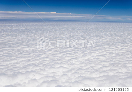 Blue sky and silky white clouds with stunning shapes and colorful views over the clouds 121305135
