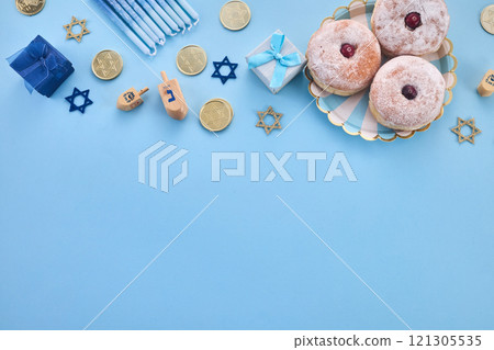 Hanukkah Celebration frame. Festive Hanukkah items on blue background Hanukkah Celebration frame. Festive Hanukkah items on blue background 121305535