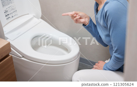 Middle-aged woman suffering from toilet trouble Middle-aged woman suffering from toilet trouble 121305624