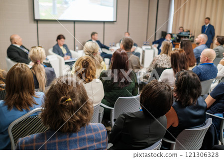 Audience Attending a Panel Discussion in a Conference Setting 121306328