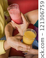 Women holding tropical fruit juice and smoothie in ecuadorian restaurant 121306759