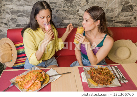 Women enjoying traditional ecuadorian cuisine and drinks in Portoviejo restaurant Women enjoying traditional ecuadorian cuisine and drinks in Portoviejo restaurant 121306760