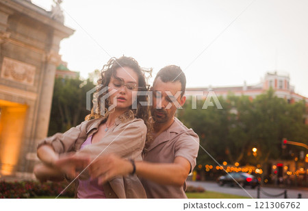 Couple dancing swing in madrid near puerta de alcala at sunset Couple dancing swing in madrid near puerta de alcala at sunset 121306762