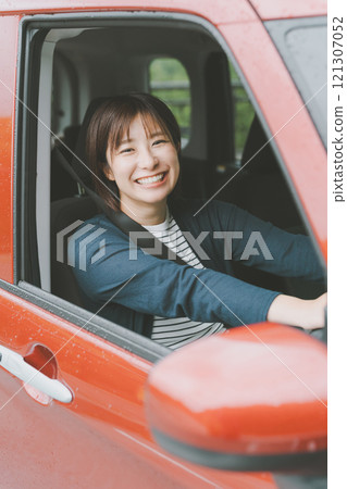 young woman driving a car young woman driving a car 121307052