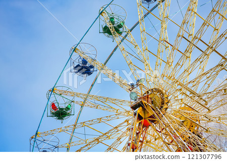 Amazing view of snow covered ferris wheel surrounded by snowcovered trees. Amazing view of snow covered ferris wheel surrounded by snowcovered trees. 121307796