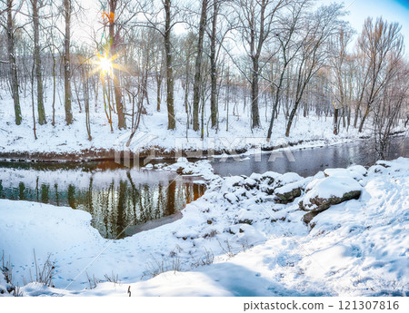 Outstanding landscape in city park with snowy trees and beautiful reflection in frozen river. Outstanding landscape in city park with snowy trees and beautiful reflection in frozen river. 121307816