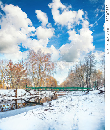 Picturesque landscape in city park with snowy trees and beautiful reflection in frozen river. Picturesque landscape in city park with snowy trees and beautiful reflection in frozen river. 121307823