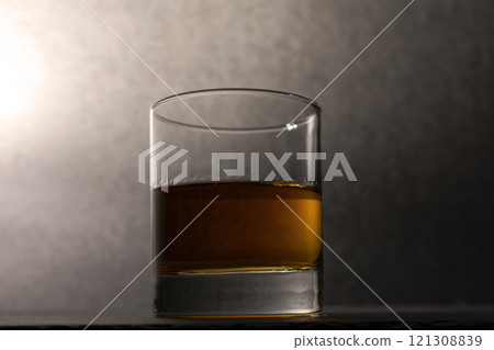 glass goblet with whiskey on a dark background glass goblet with whiskey on a dark background 121308839