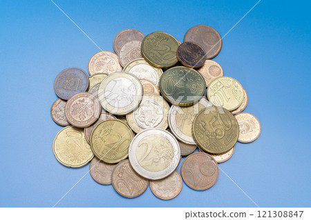 a handful of euro cent coins on a blue background a handful of euro cent coins on a blue background 121308847